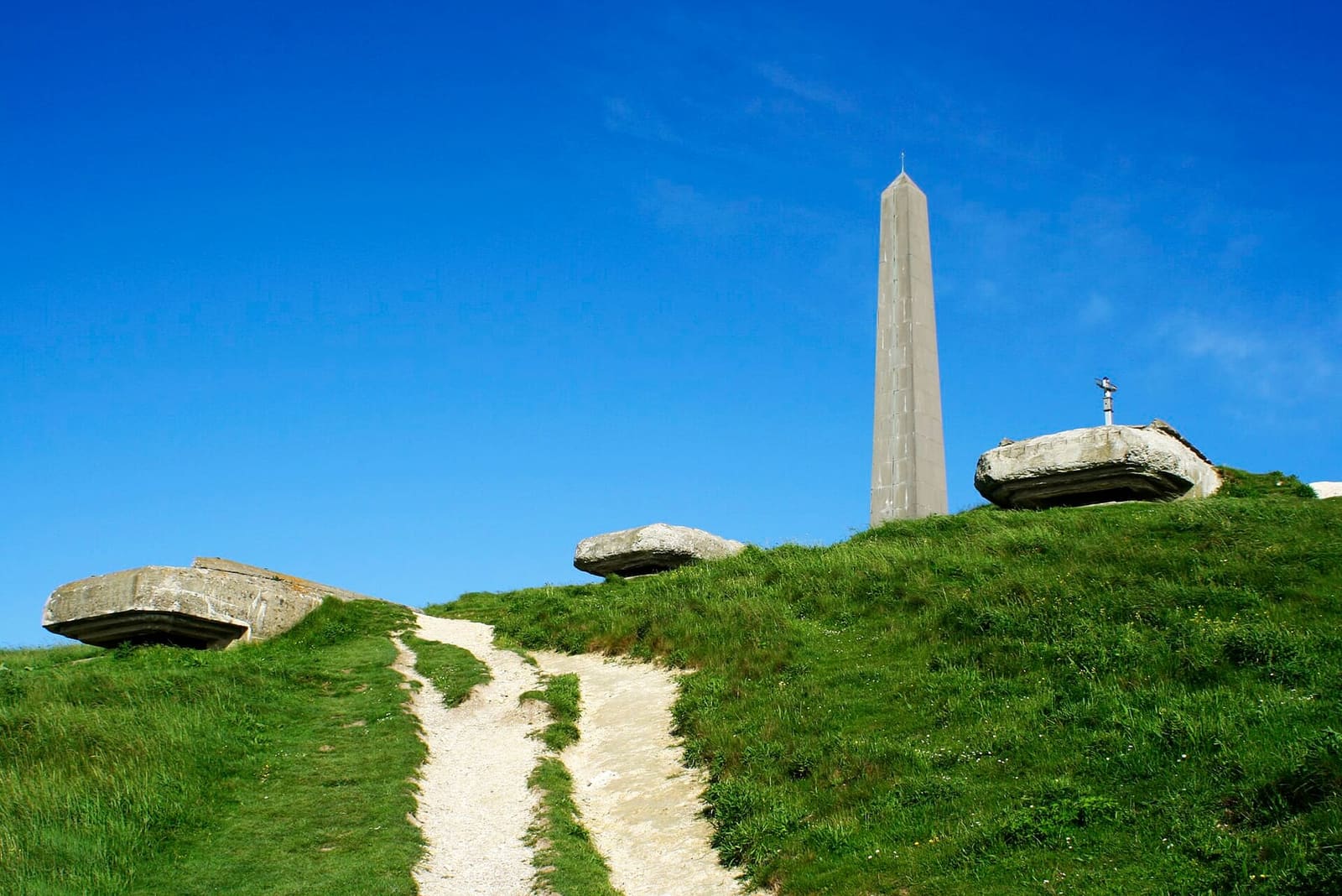 the white path climbing to the Dover Patrol obelisk, between bunkers and grass