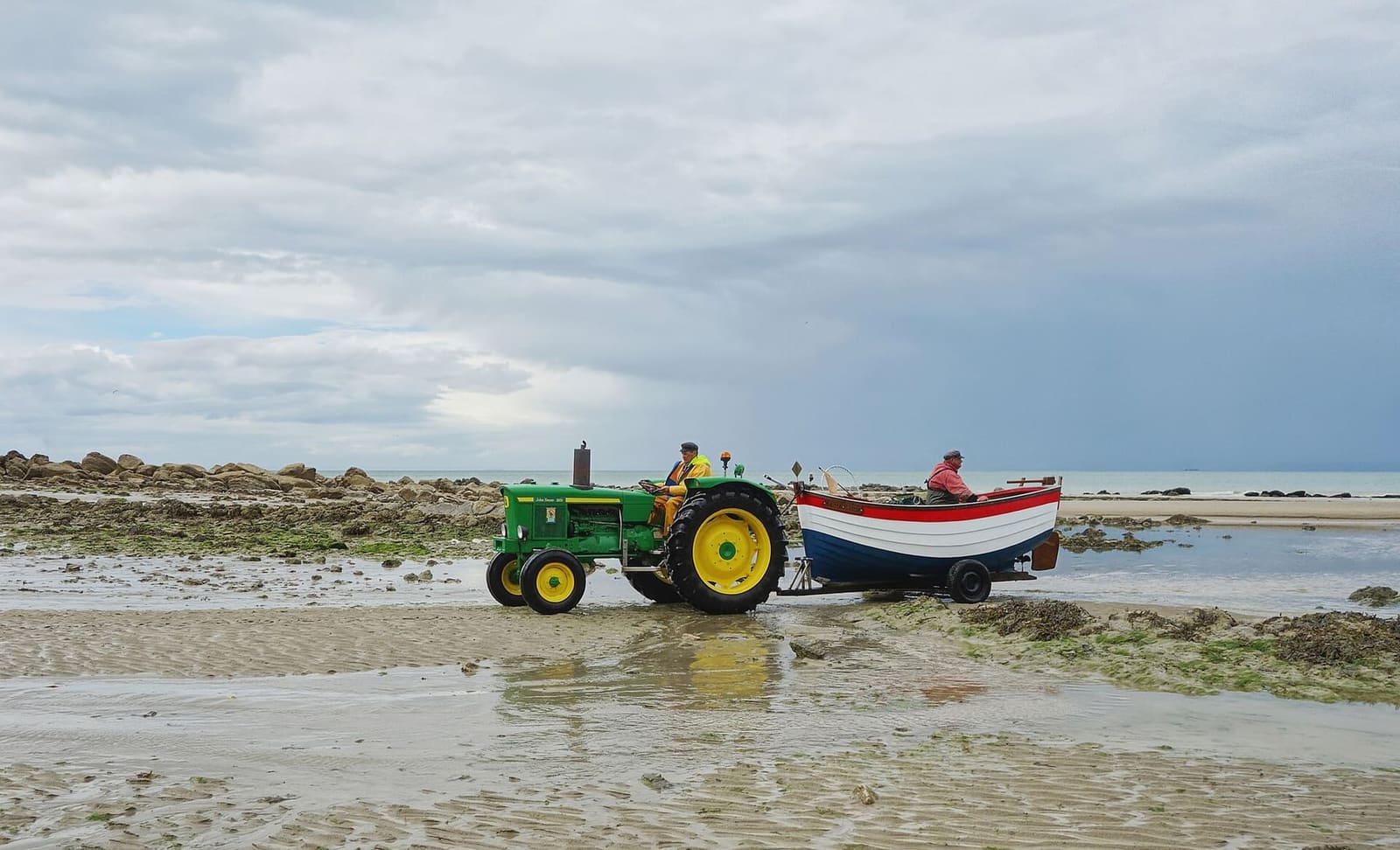 a tractor pulling a flobart, the fishermen's beach boat, on the beach at Gris-Nez