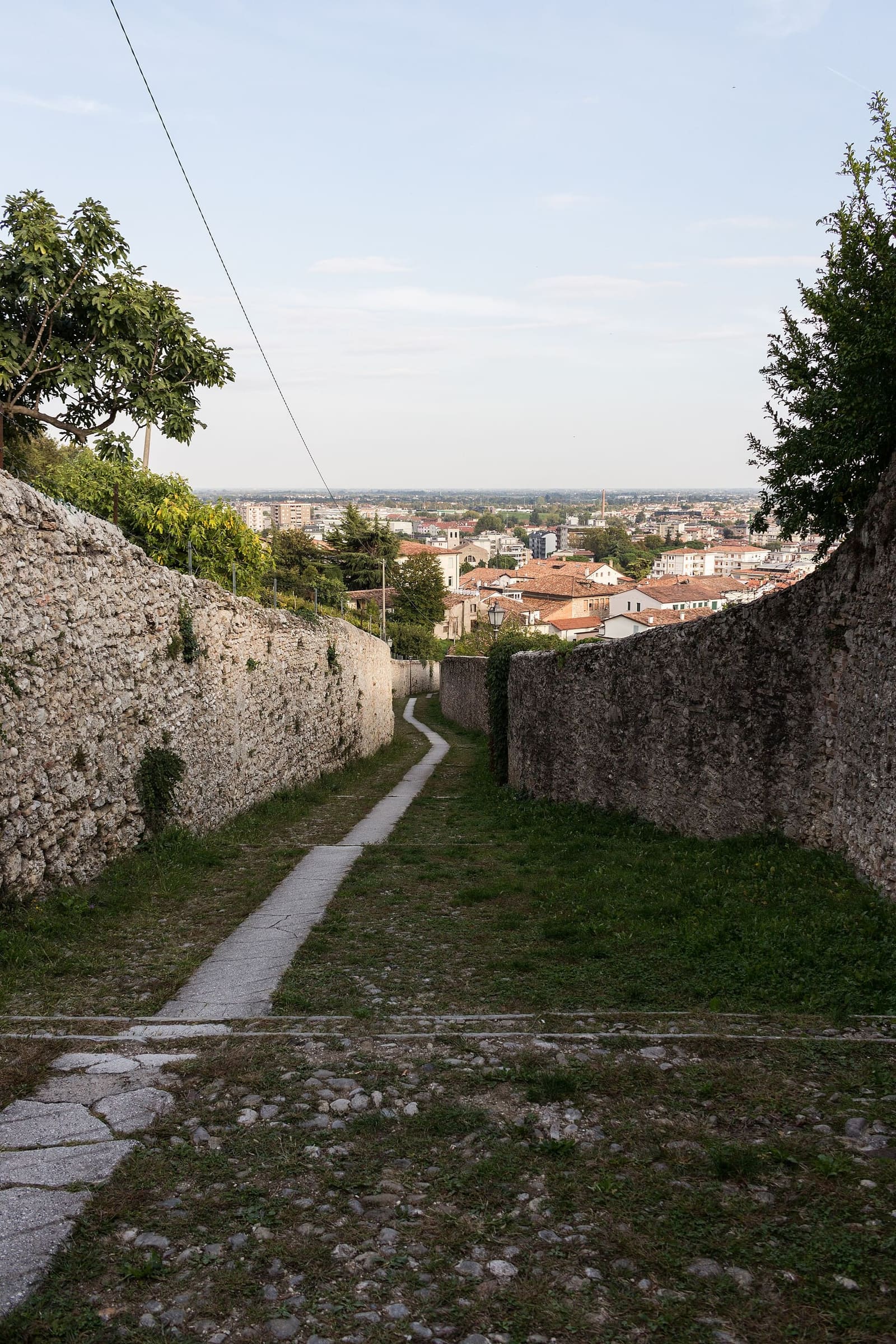la calle della Madonna della Neve che scende dal castello fra le mura, con la città in fondo