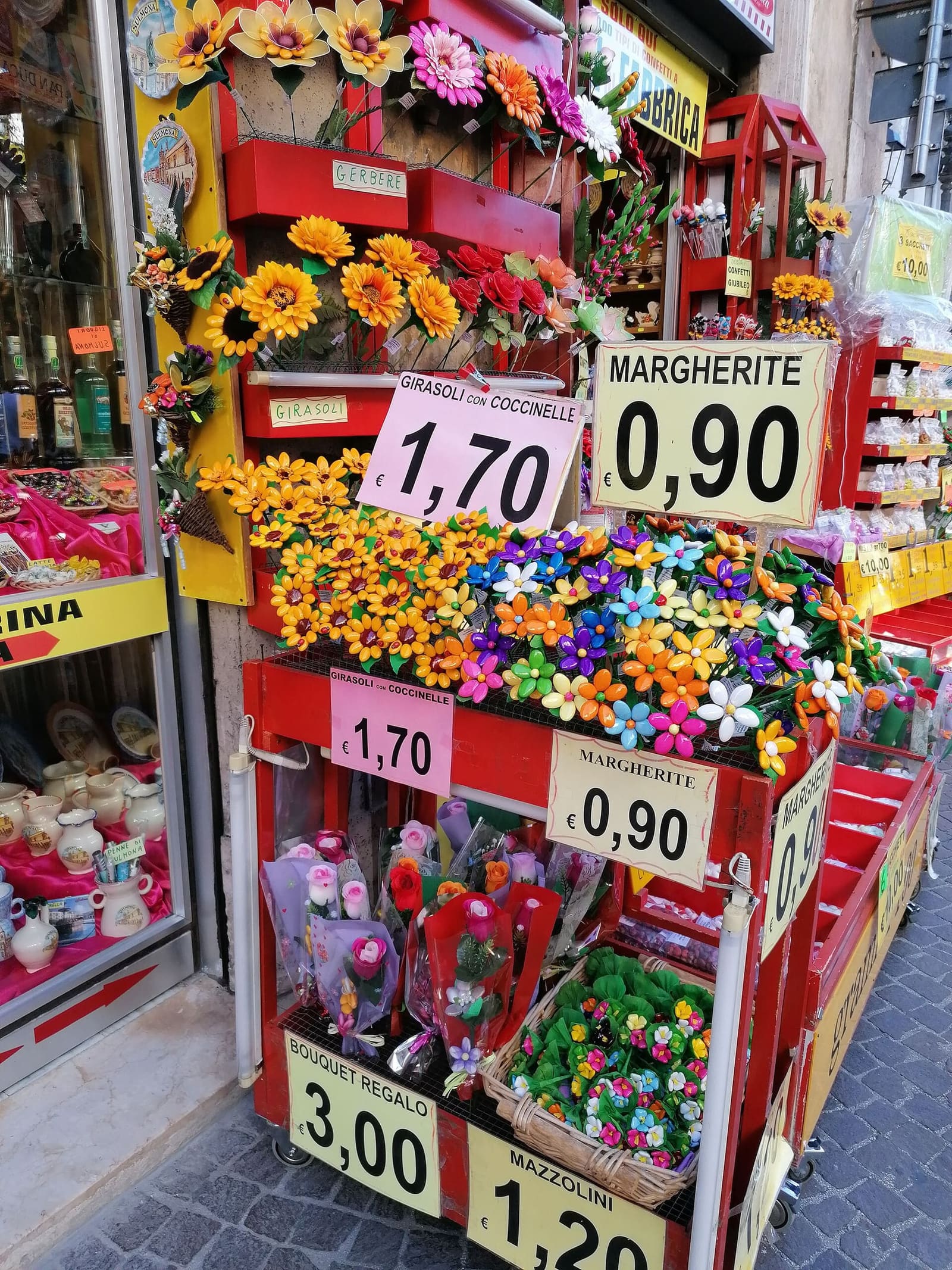the stall of confetti flowers in front of a shop in Sulmona, with sunflowers, daisies and small bouquets, in September 2020
