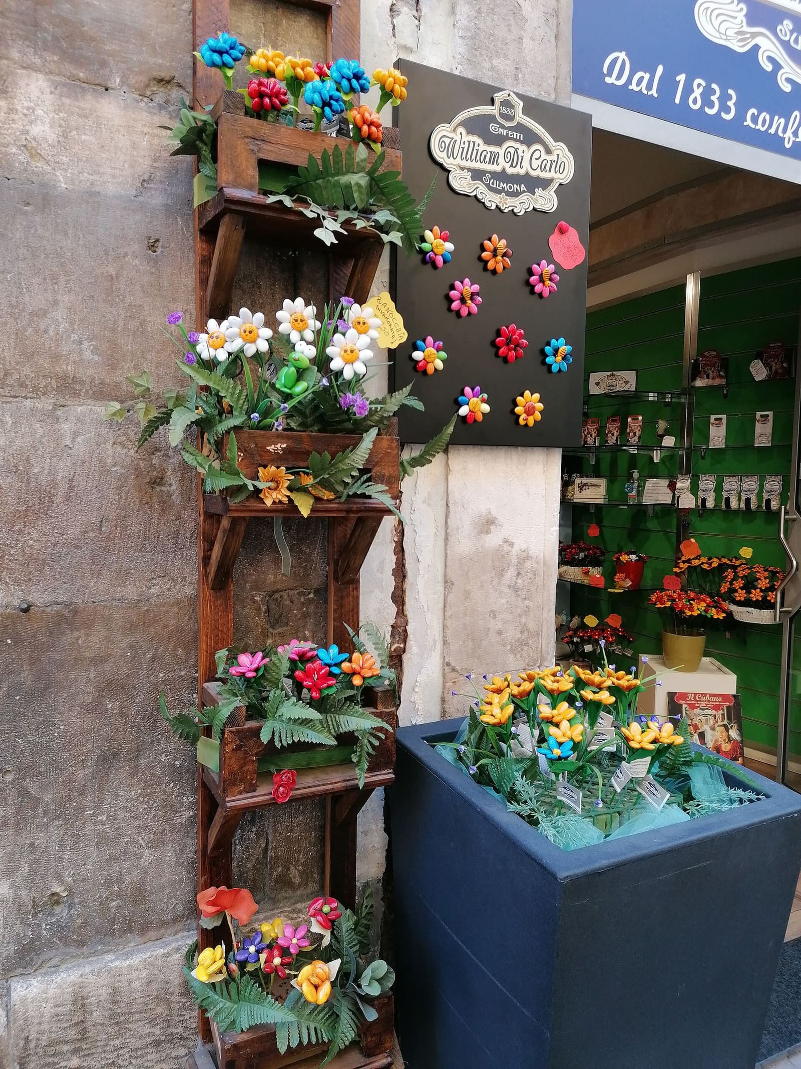 confetti flowers and daisies hanging at the entrance of the William Di Carlo shop in Sulmona