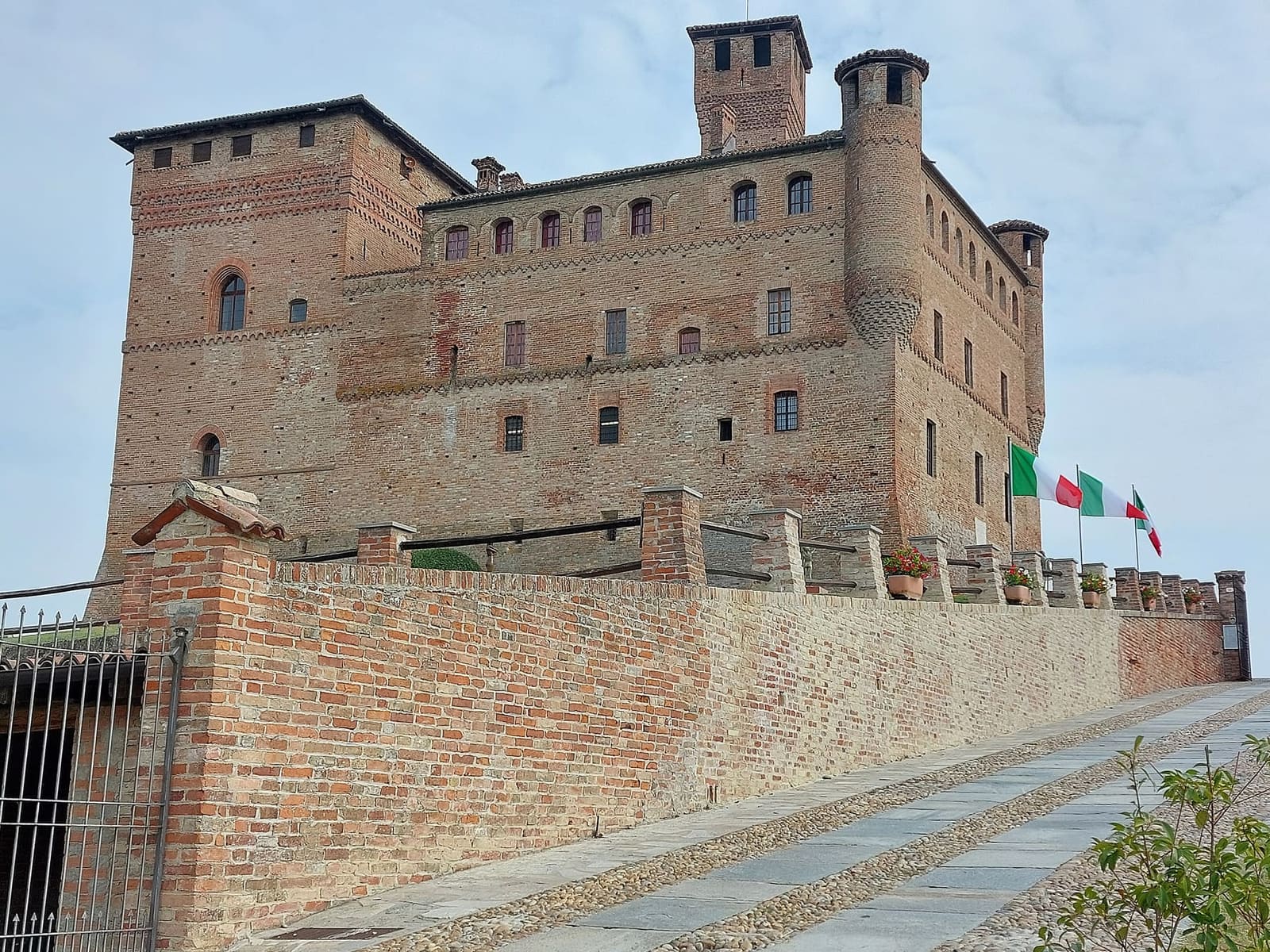 la rampa che sale al castello lungo il muro di cinta, con le bandiere