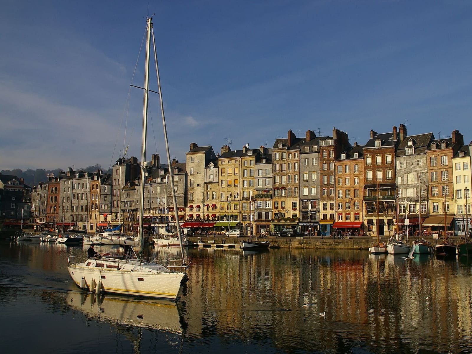 die Häuser des Quai Sainte-Catherine im warmen Morgenlicht, gespiegelt im Wasser des Vieux Bassin, im November