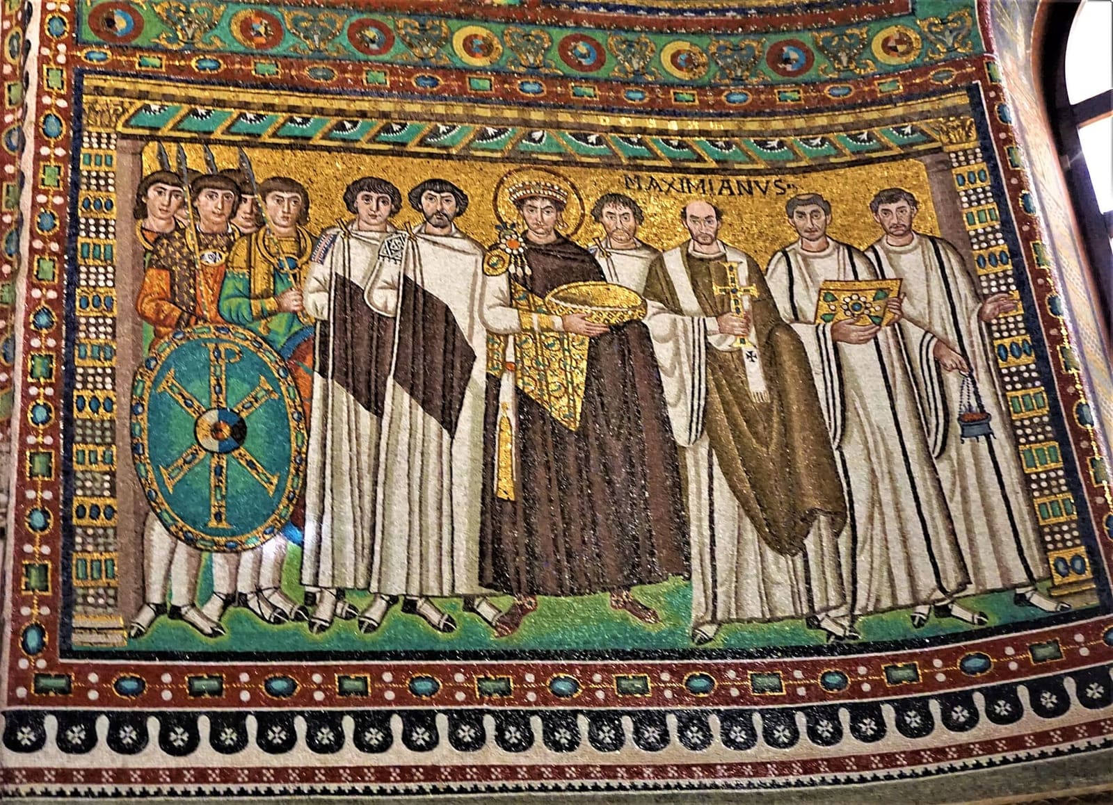the emperor Justinian with the gold paten among the dignitaries, the soldiers and bishop Maximian, in the presbytery of San Vitale