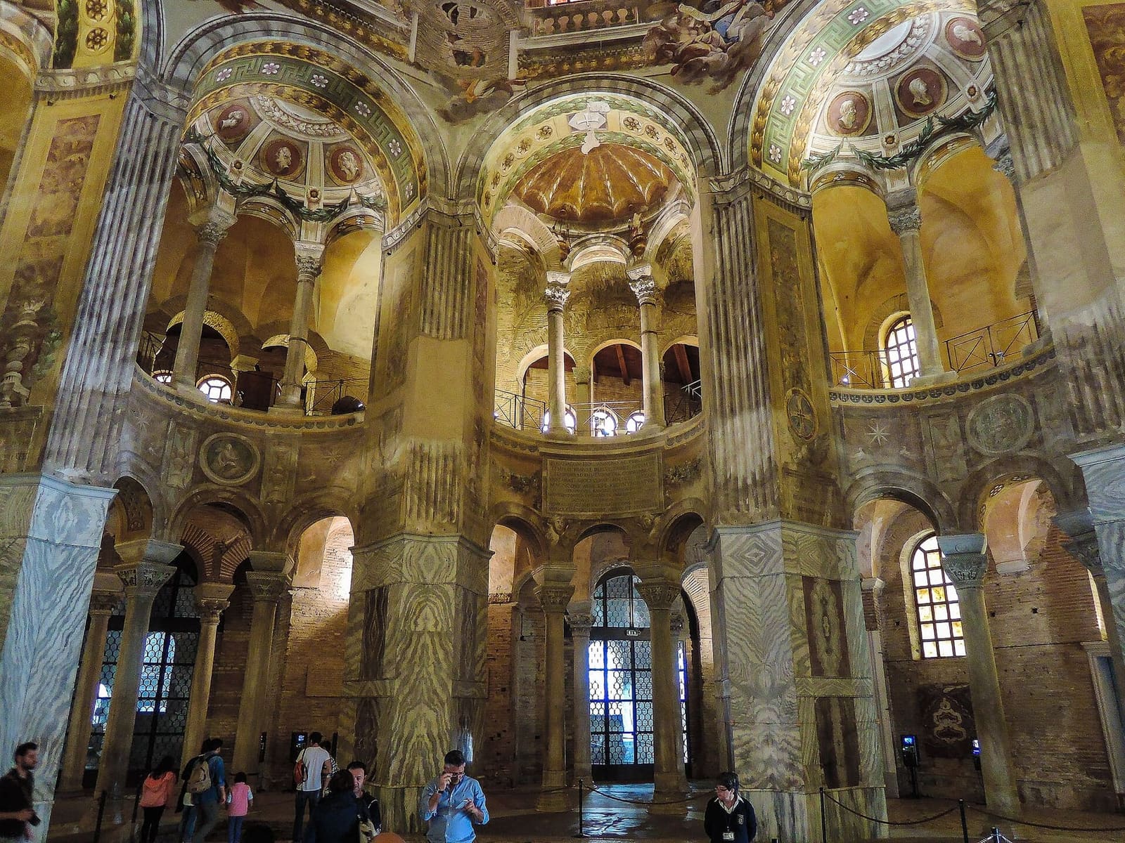 the octagonal interior of San Vitale with the colonnaded exedrae and the women's galleries