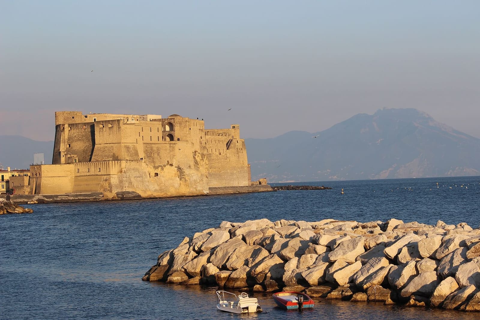 Castel dell'Ovo nella luce della sera, con il Vesuvio dietro