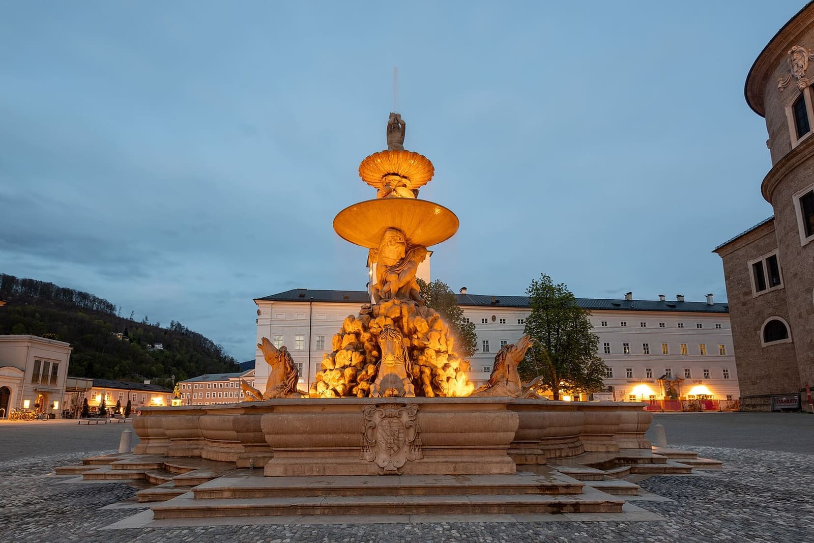 la fontana della Residenzplatz illuminata al tramonto, davanti alla Residenza