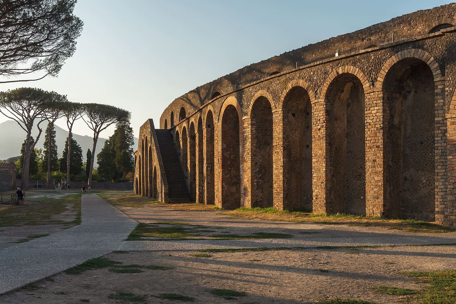 the Amphitheatre from outside, with its arches and stairways, among the pines