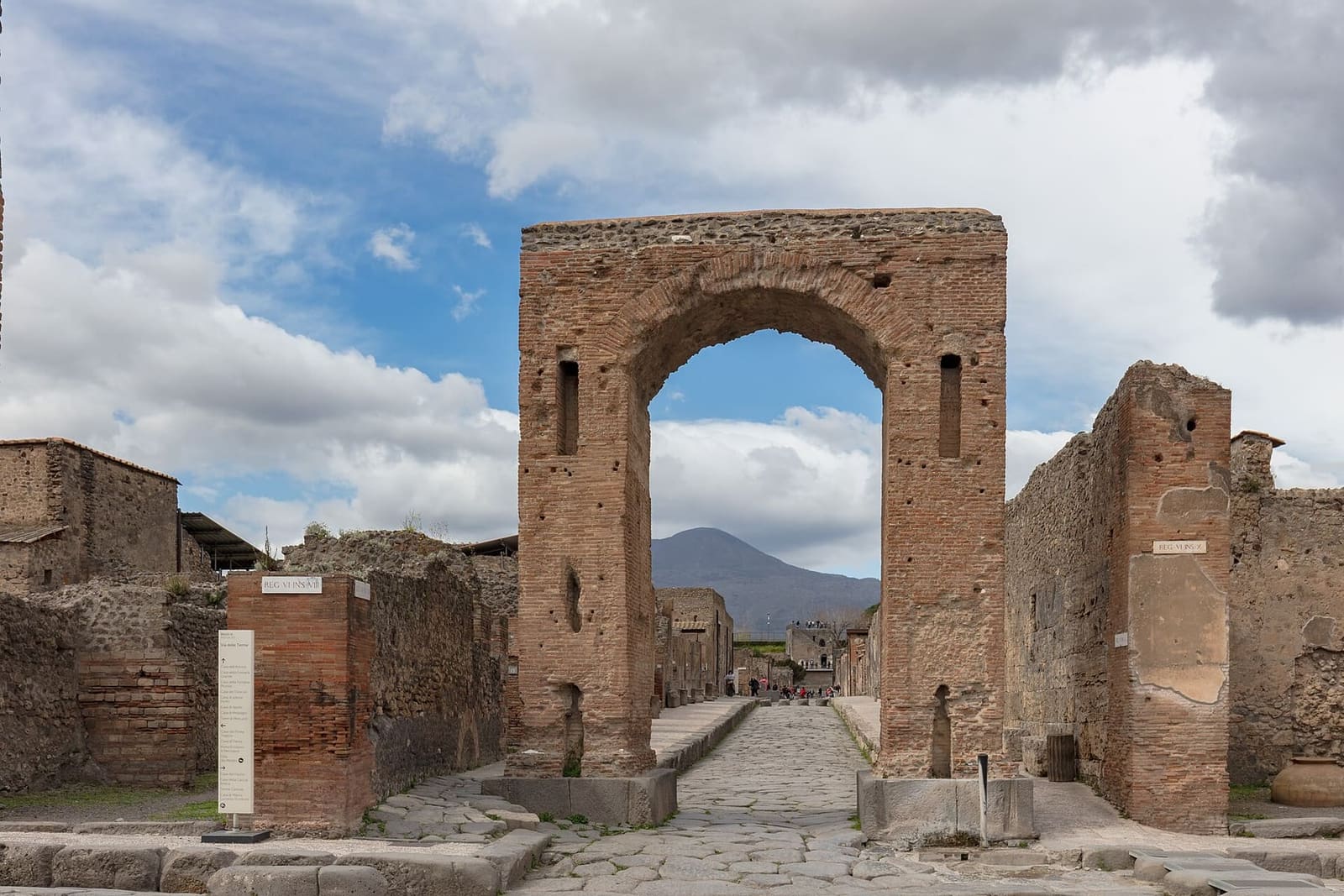 the Arch of Caligula on via di Mercurio, with Vesuvius framed inside the arch