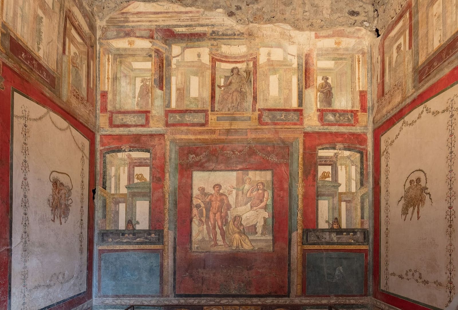 a room in the Casa dei Vettii, with mythological pictures on the red walls