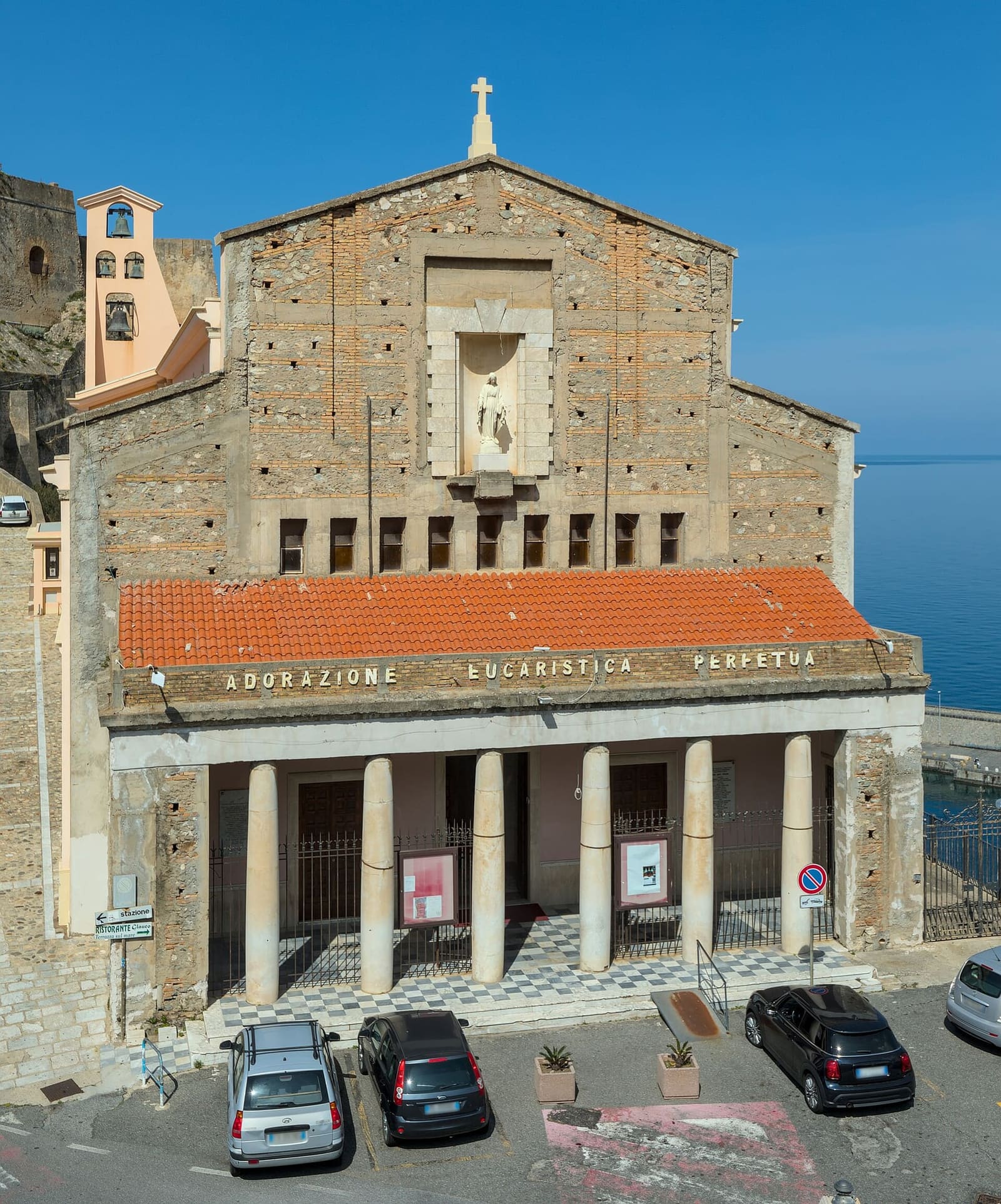 the church of the Immacolata with its portico of columns, at the foot of the rock