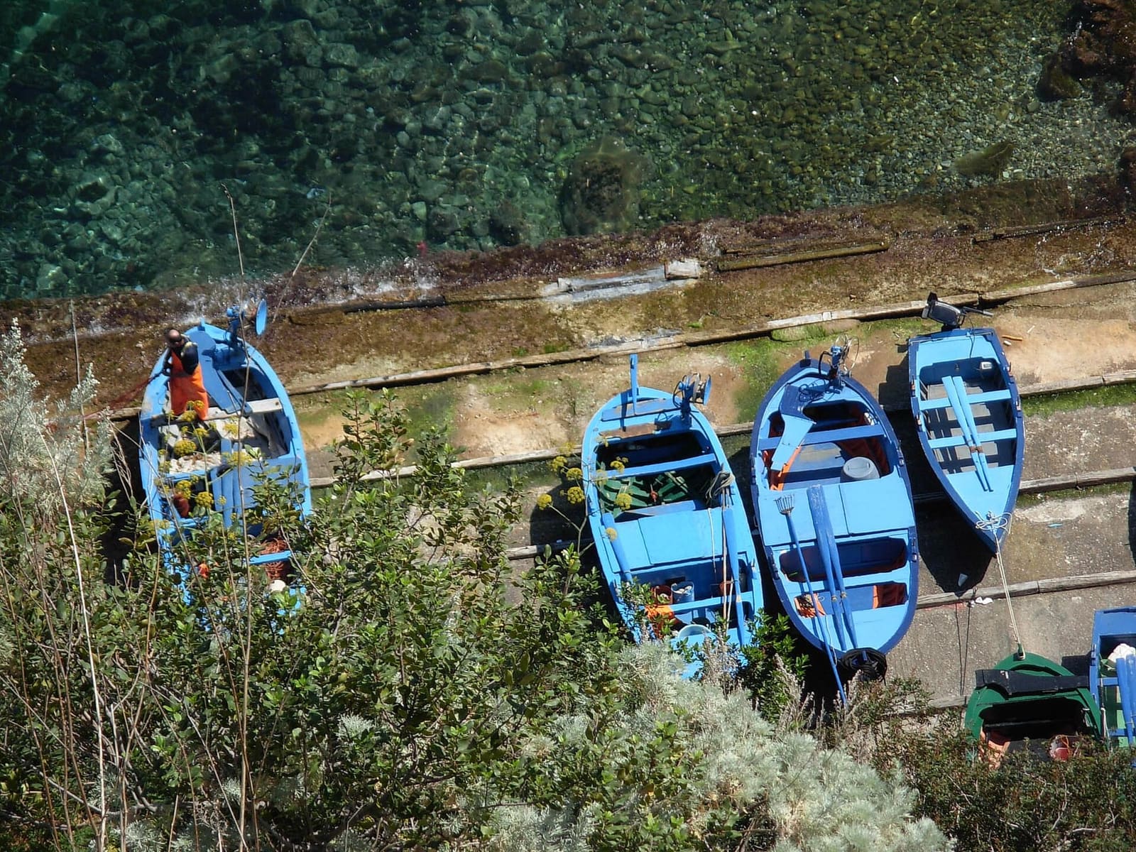 the fishermen's blue boats pulled up on dry land, seen from above