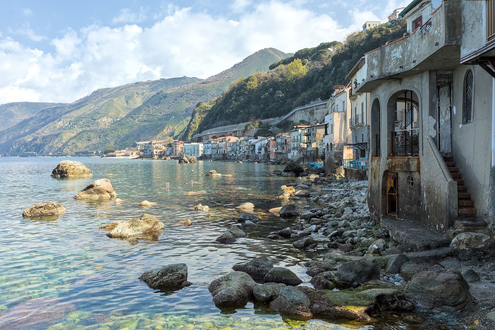 the houses of Chianalea on the rocks, with the Costa Viola in the distance