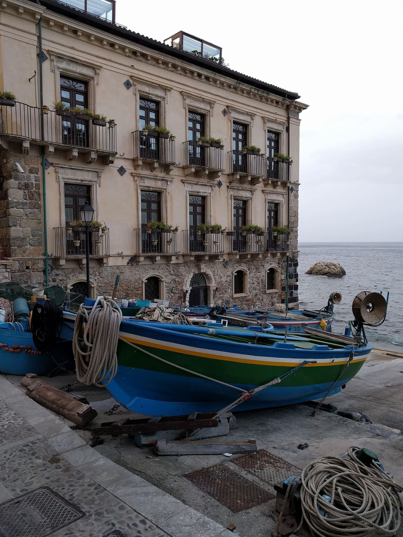 a building of Chianalea on the sea and a boat on dry land with its ropes