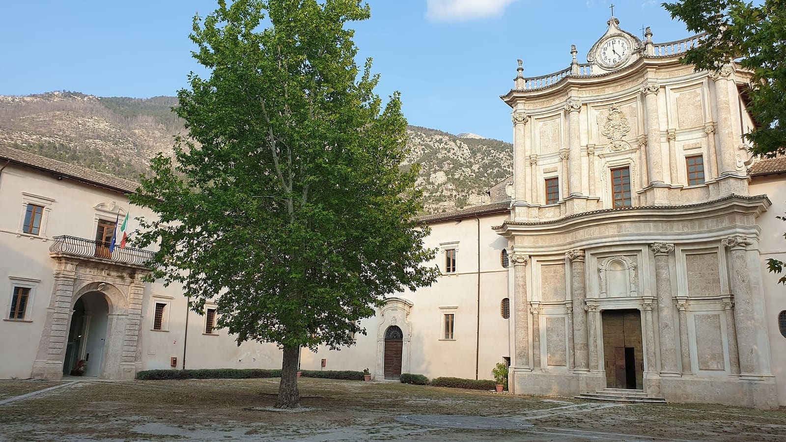 the courtyard of the Badia Morronese with the Baroque facade of the church