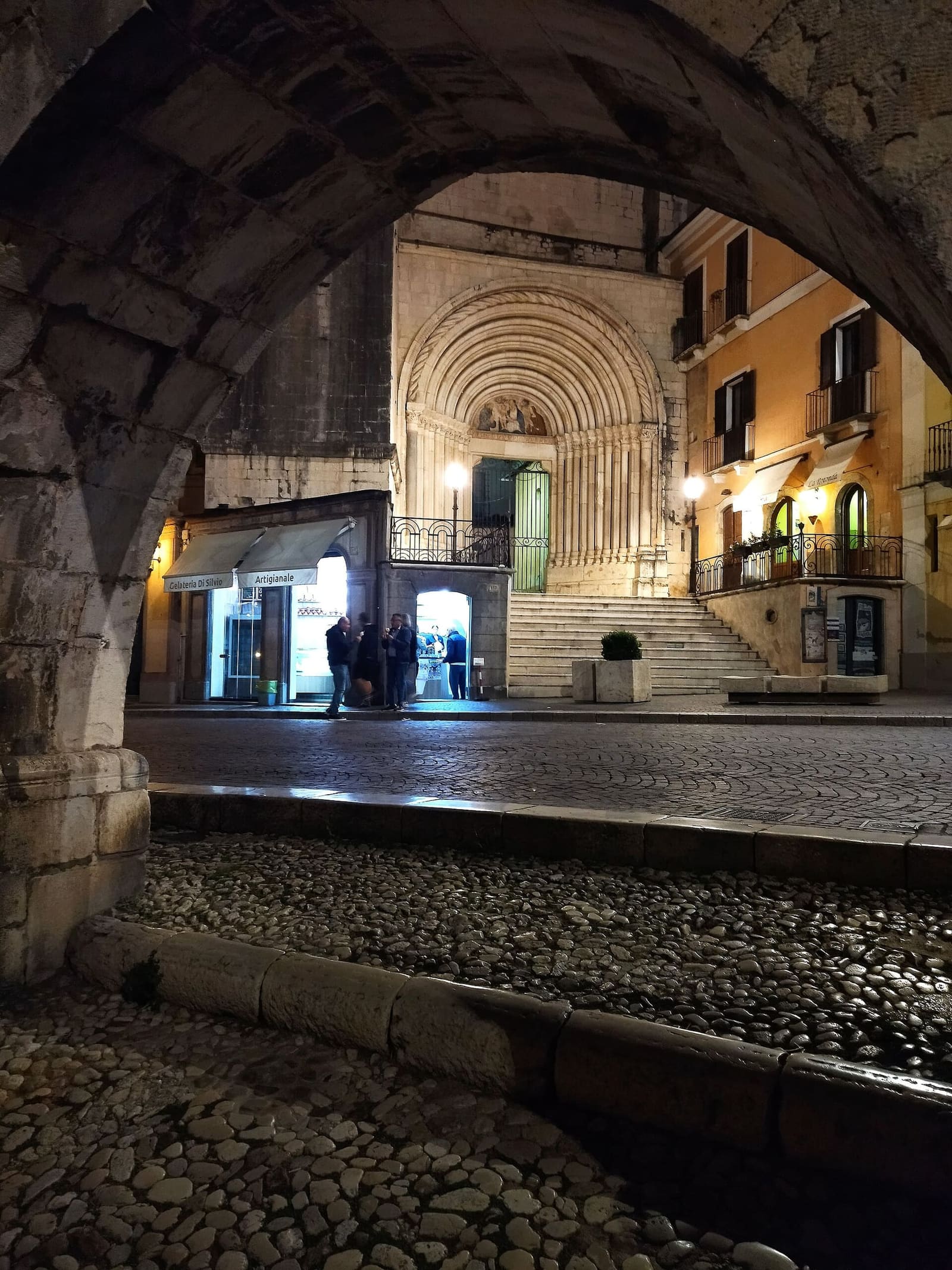 the doorway of the Rotonda di San Francesco della Scarpa seen in the evening from under the aqueduct