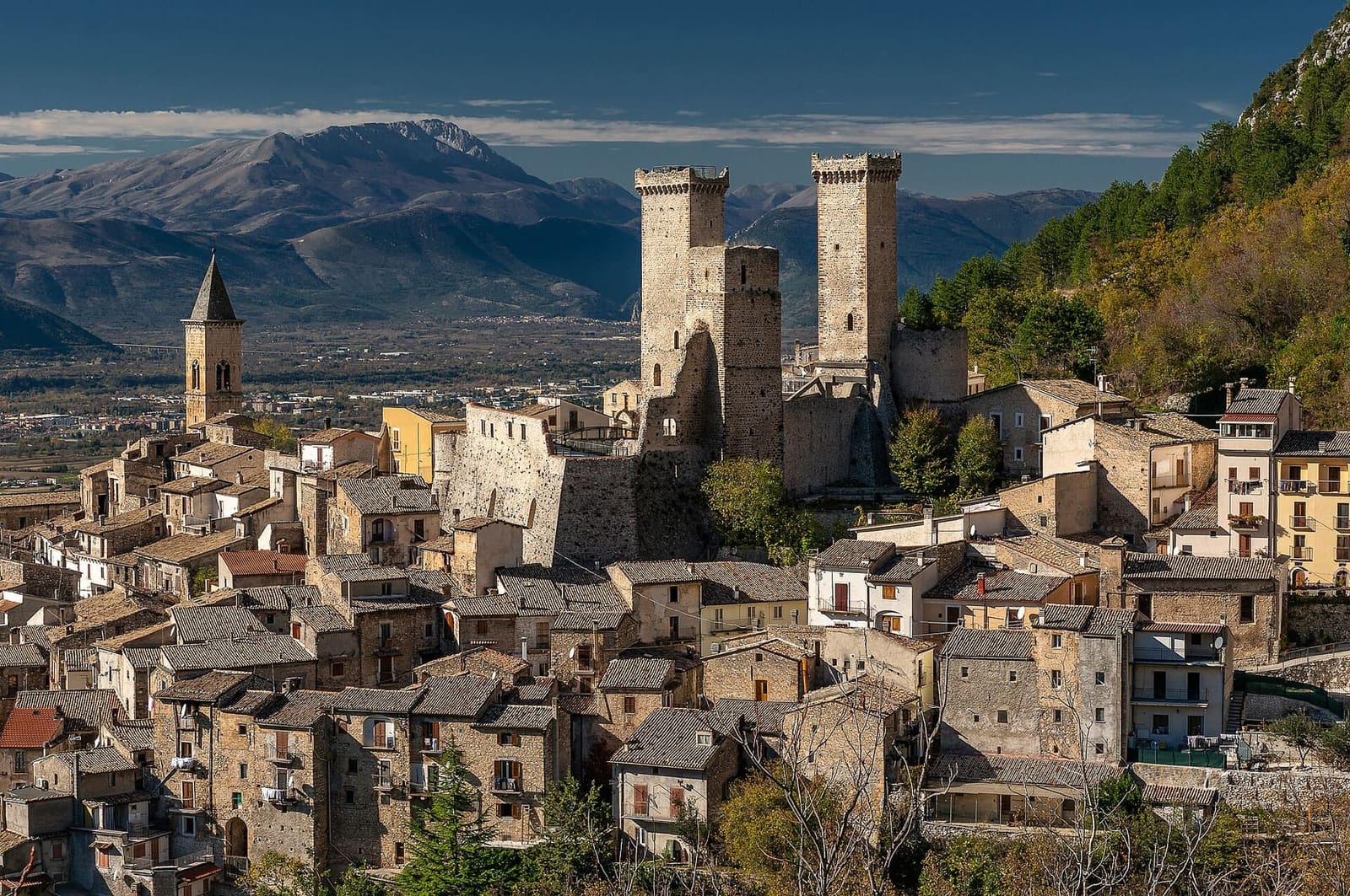 Pacentro with the towers of the castello Caldora and the bell tower, below the mountains