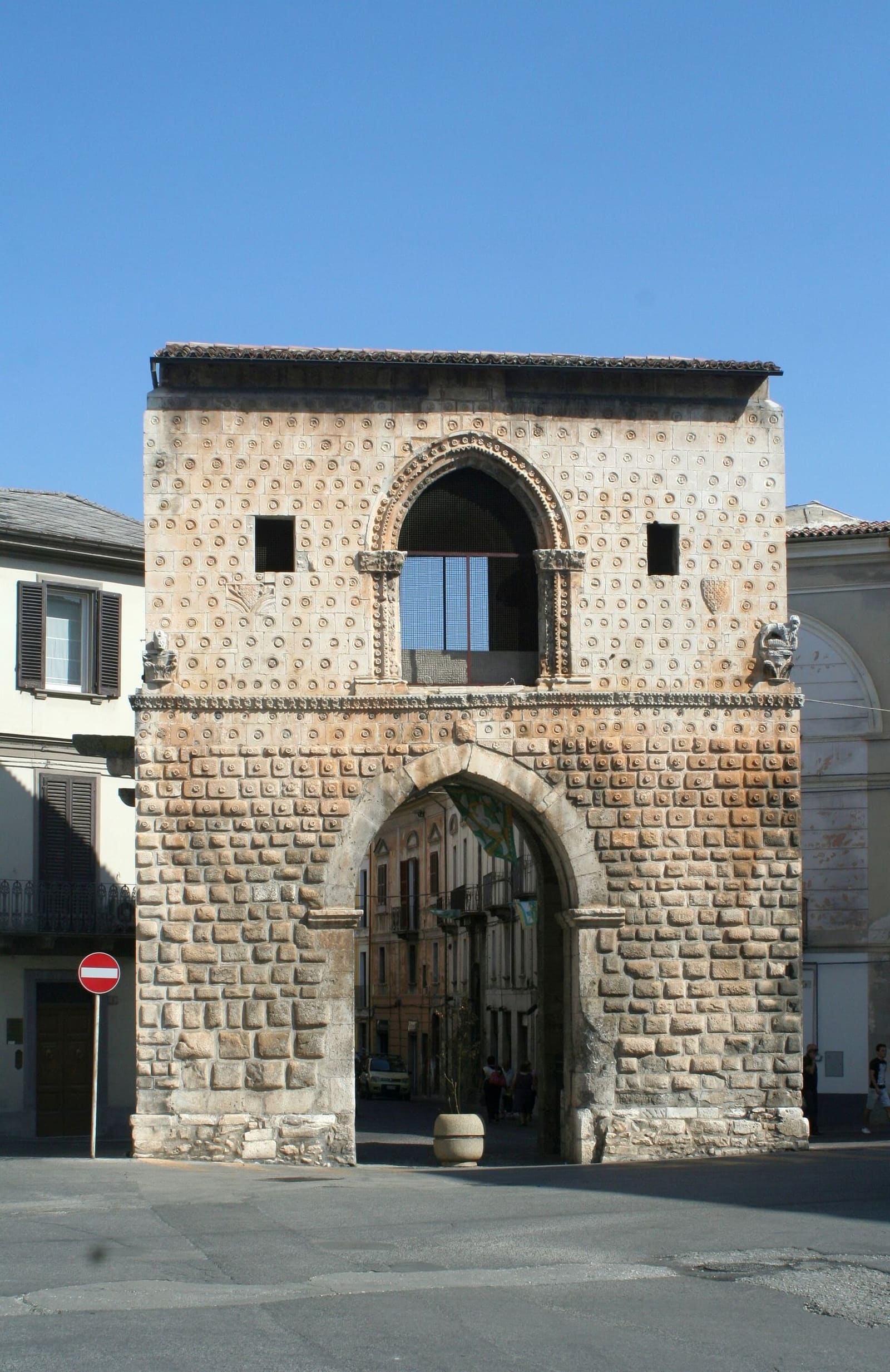 Porta Napoli at the end of corso Ovidio, with its stonework of small rosettes