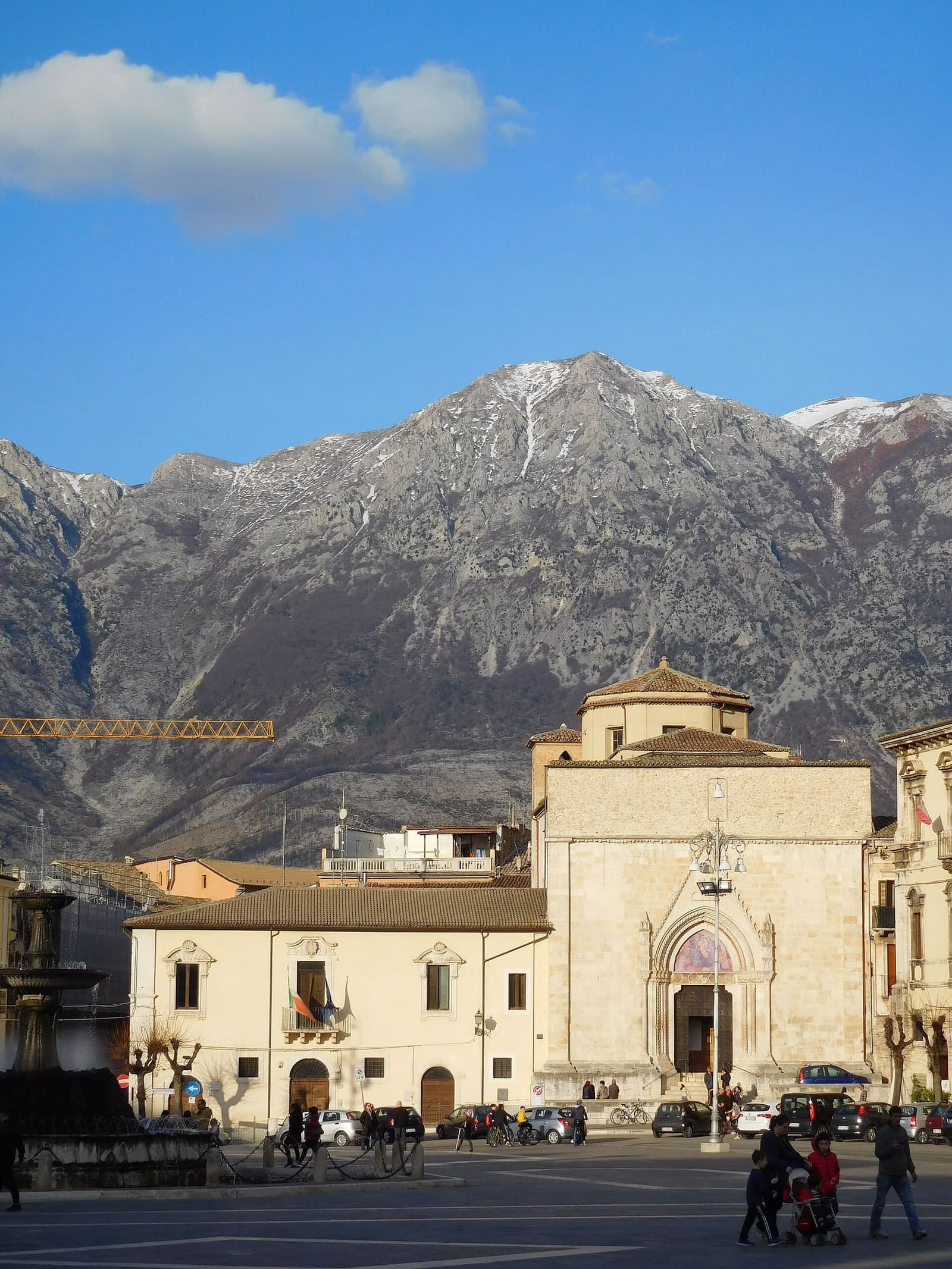 the church of San Filippo Neri with its Gothic doorway on piazza Garibaldi, and the snow-capped Morrone