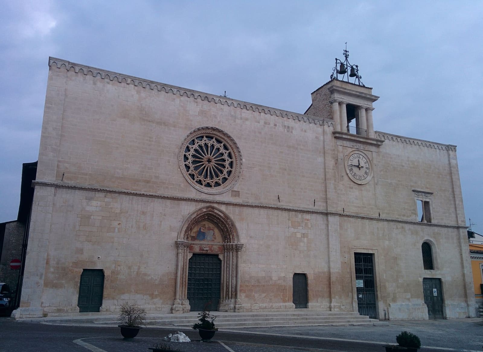 the facade of Santa Maria della Tomba with its doorway and rose window