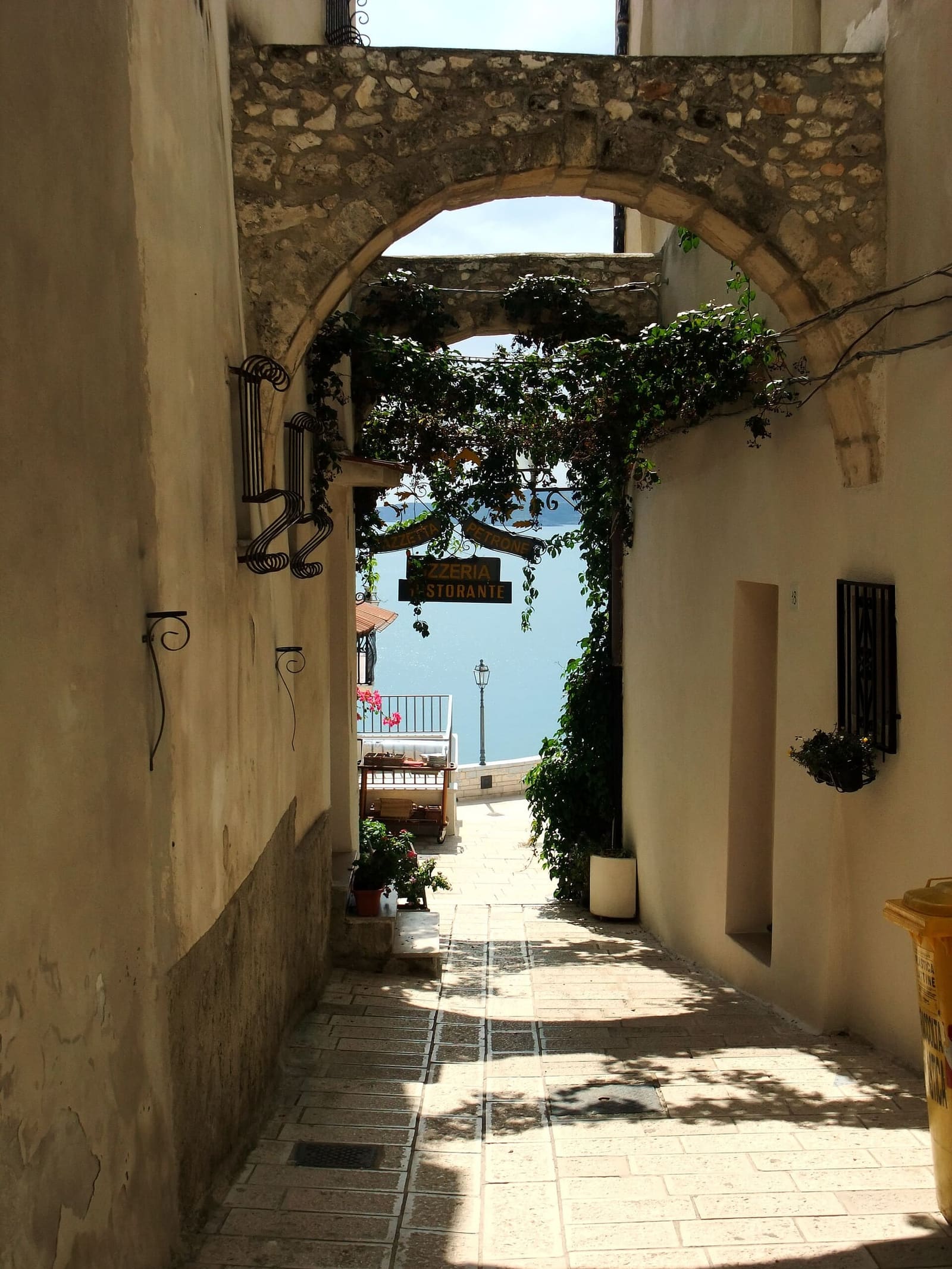 eine Gasse der Altstadt, die unter einem Bogen zum Meer hinunterführt